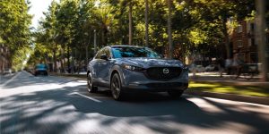 2025 mazda cx 30 driving down a busy street