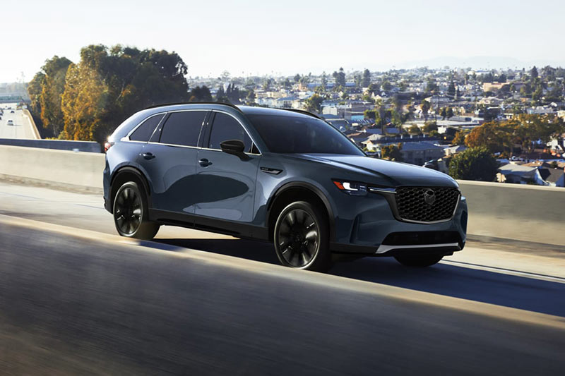2026 Mazda CX-90 SUV on city road with safety features